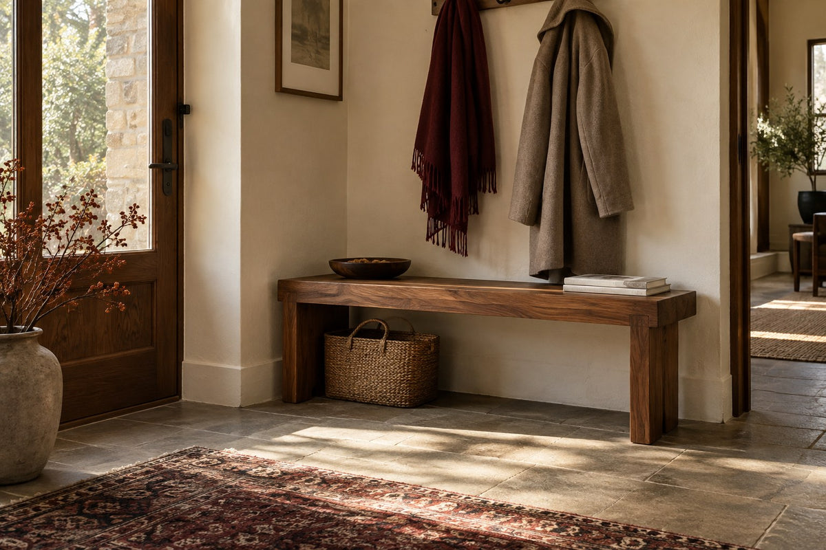 Interior inspiration: a walnut entryway bench with a coat and burgundy scarf; styling items are not included